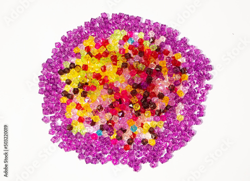 Over head shot of a Pile of colorful beads on a white background