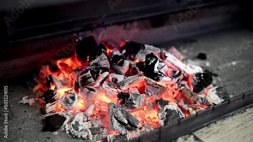 Brazier with fire and coals for cooking on fire in nature.Family vacation. Closeup shot of charcoal burning