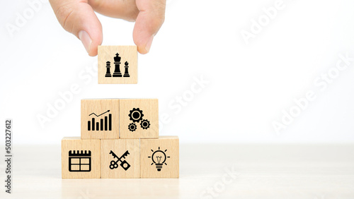 Hand choose king chess on business strategy plan icon concept of financial research for management to success and growth. © Jintana