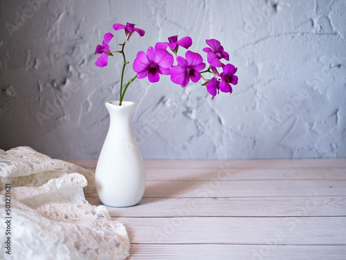 Purple flowers in vase on the table,Purple-pink flower orchids still life background or wallapper cooktown ,Dendrobium bigibbum mauve butterfly orchid ,Callista bigibba Callista sumneri blooming  photo