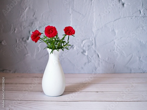 Red flowers in vase on table still life flowers for background or wallpaper ,red moss rose purslane portulaca grandiflora ,text message writing ,Valentine's day ,love card design ,romantic lovely 