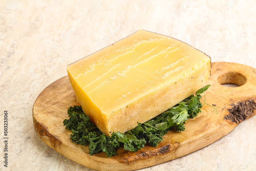 Parmesan cheese piece over board Parmesan cheese piece over board