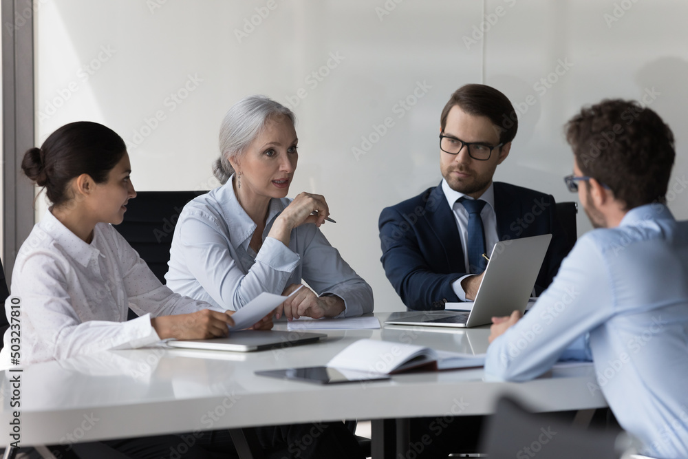 Diverse recruit team meeting, talking to job candidate for interview. HR group searching staff, hiring new employee, sitting at conference table discussing job experience Diverse recruit team meeting, talking to job candidate for interview. HR group searching staff, hiring new employee, sitting at conference table discussing job experience