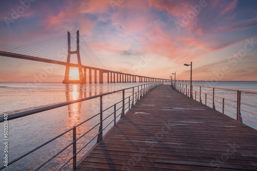 The Vasco da Gama Bridge is a landmark  and one of the longest bridges in the world. Urban landscape. Sunrise. Portugal is an amazing tourist destination