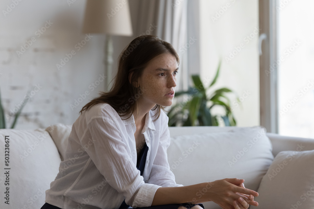 Concerned nervous young woman suffering from anxiety disorder, stress, depression, feeling frustrated, worried, going through loss, grief, emotional trauma, addiction. Emotional crisis concept Concerned nervous young woman suffering from anxiety disorder, stress, depression, feeling frustrated, worried, going through loss, grief, emotional trauma, addiction. Emotional crisis concept