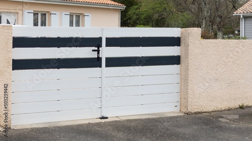 portal suburban steel metal gate white grey of home suburb street access house garden