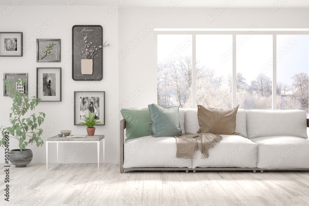 Fototapeta premium White living room with sofa and winter landscape in window. Scandinavian interior design. 3D illustration
