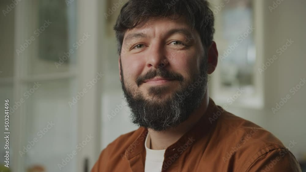 Portrait of a young adult caucasian man smiling and looking at camera Portrait of a young adult caucasian man smiling and looking at camera