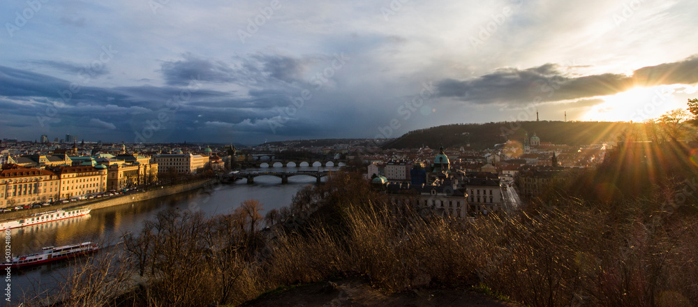 Scenic spring, summer sunset view of the Old Town pier architecture and Charles Bridge and others bridges over Vltava river in Prague, Czech Republic