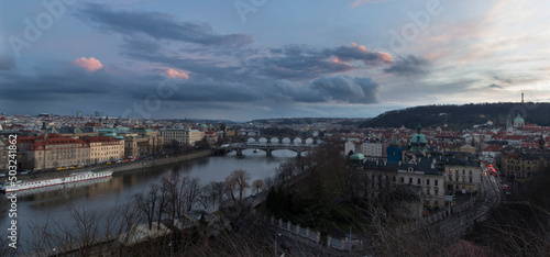 Scenic spring, summer sunset view of the Old Town pier architecture and Charles Bridge and others bridges over Vltava river in Prague, Czech Republic