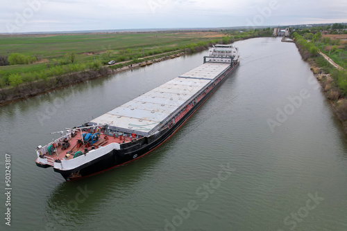 Cargo transportation. Cargo ship on the river in Russia. Volga-Don shipping canal in Volgograd. Russia