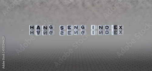 hang seng index word or concept represented by black and white letter cubes on a grey horizon background stretching to infinity photo