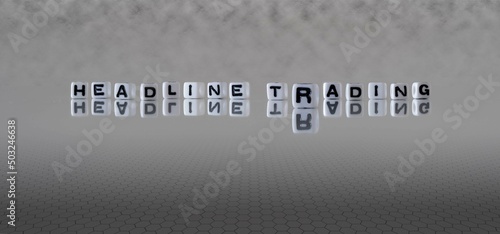 headline trading word or concept represented by black and white letter cubes on a grey horizon background stretching to infinity