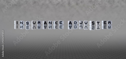 insurance adjuster word or concept represented by black and white letter cubes on a grey horizon background stretching to infinity