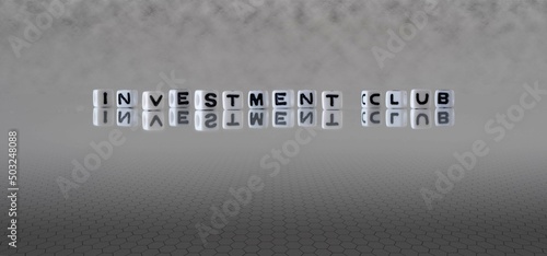 investment club word or concept represented by black and white letter cubes on a grey horizon background stretching to infinity