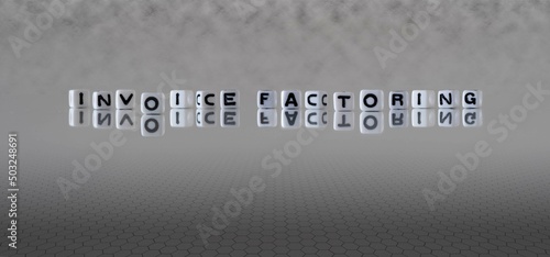 invoice factoring word or concept represented by black and white letter cubes on a grey horizon background stretching to infinity photo