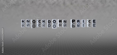 knockdown price word or concept represented by black and white letter cubes on a grey horizon background stretching to infinity