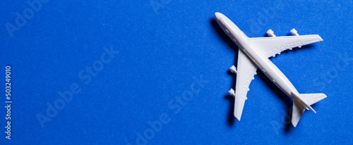 A miniature airplane isolated on blue background, Travel or traffic background, Nobody