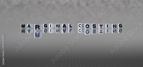 marginal costing word or concept represented by black and white letter cubes on a grey horizon background stretching to infinity
