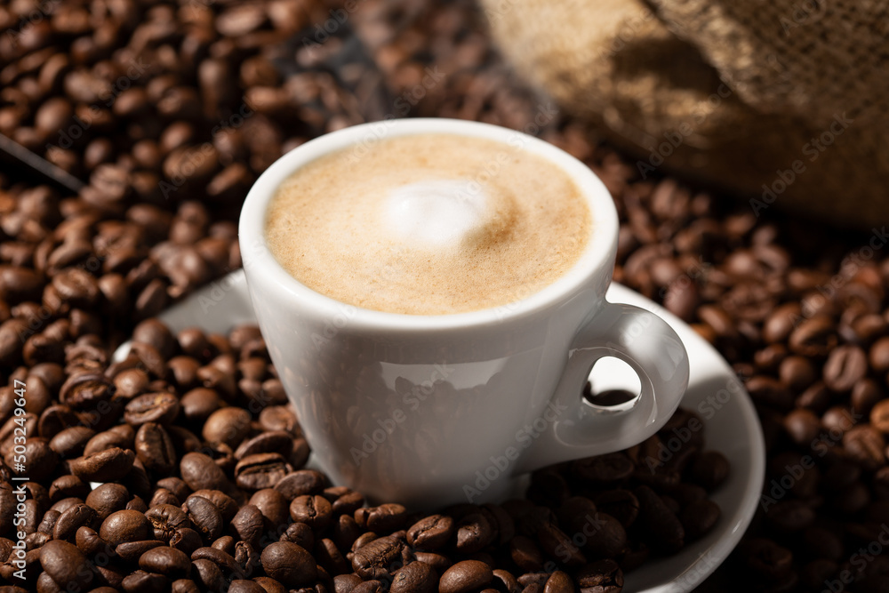 Cappuccino or Coffee with milk cup and roasted beans Cappuccino or Coffee with milk cup and roasted beans