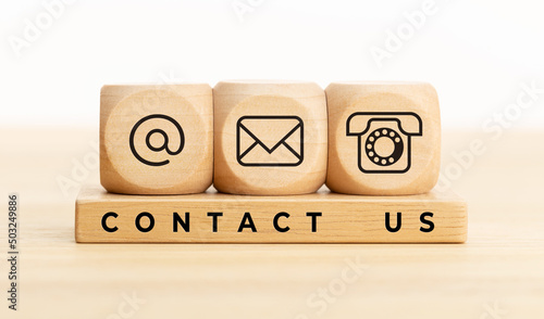 Contact us concept. Wooden blocks with email, mail and telephone icons.Website page contact us or e-mail marketing