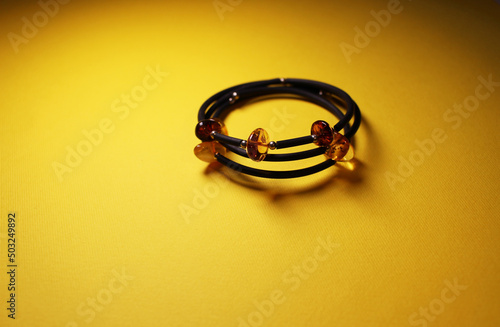 beautiful bracelet with amber on a yellow background