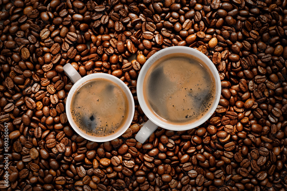 Cup of coffee with coffee beans on table Cup of coffee with coffee beans on table