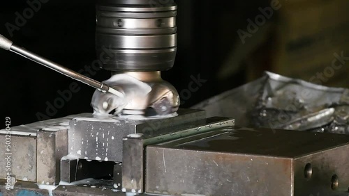 Industrial metalworking cutting automation process by milling CNC.Micro machining process , Coolant and lubrication.Close up of CNC machine at work.