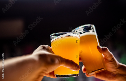 фотография two glass of beer in man hand