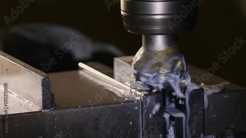 Industrial metalworking cutting automation process by milling CNC.Micro machining process , Coolant and lubrication.Close up of CNC machine at work.
