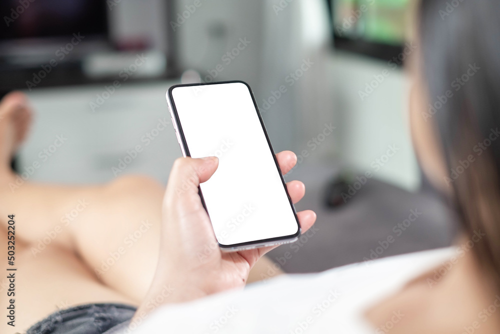 mockup phone in woman hand showing white screen at home, taken from the rear view,minimal concept mockup phone in woman hand showing white screen at home, taken from the rear view,minimal concept