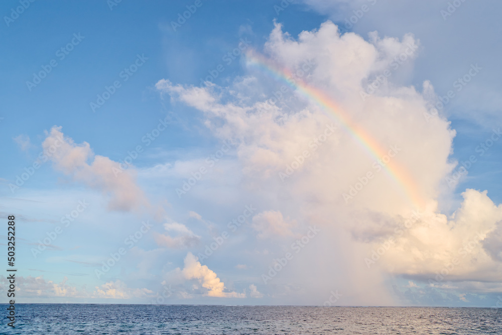 Beautiful seascape. Rainbow on horizon.