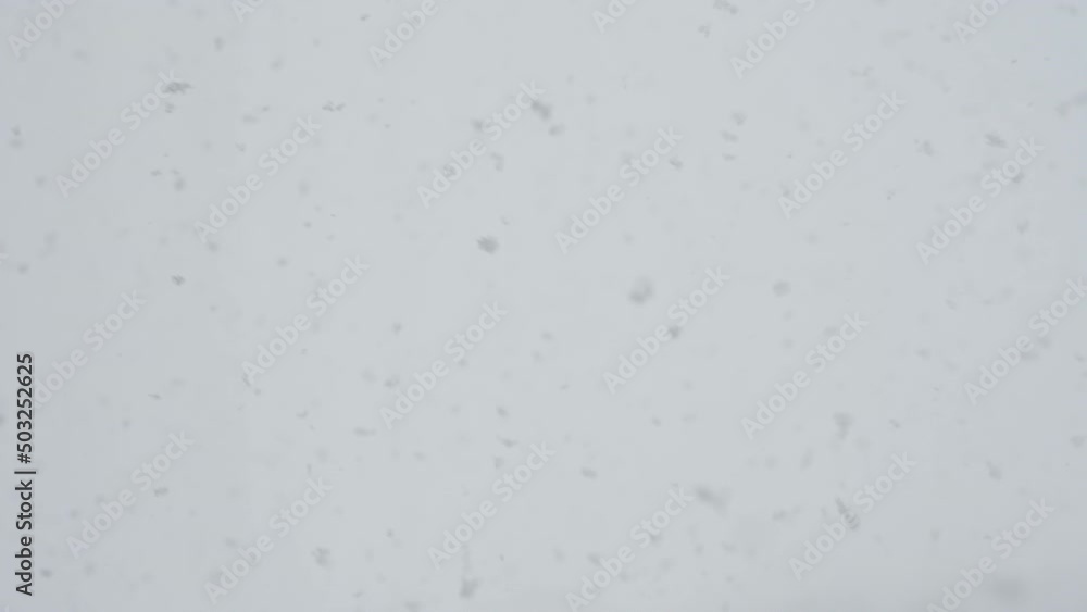 Slow motion snow falling over white clouds Slow motion snow falling over white clouds