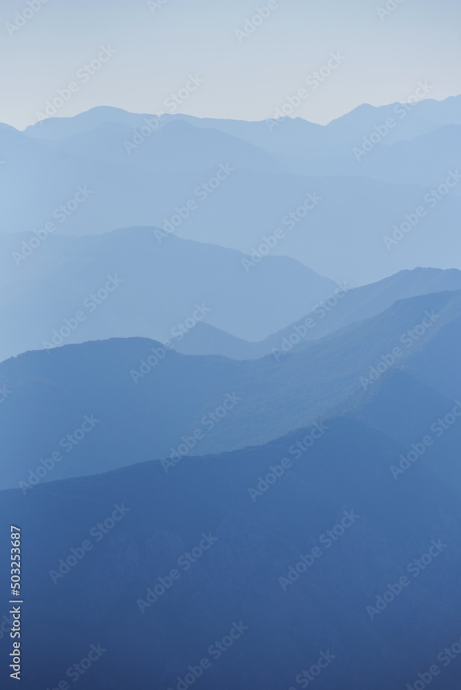 Blue mountain range silhouette with morning haze