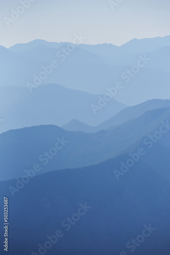 Fototapeta Naklejka Na Ścianę i Meble -  Blue mountain range silhouette with morning haze