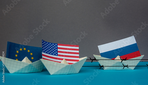 paper ship with national flag of Russia, united states of america and Europe union concept of sanctions and partnerships and free trade agreement, confrontation photo