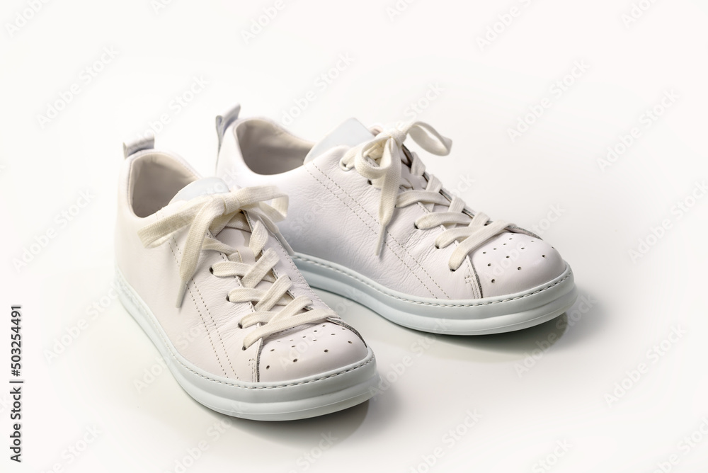 Pair of Stylis New White Sneakers Over White Background. Horizontal Image
