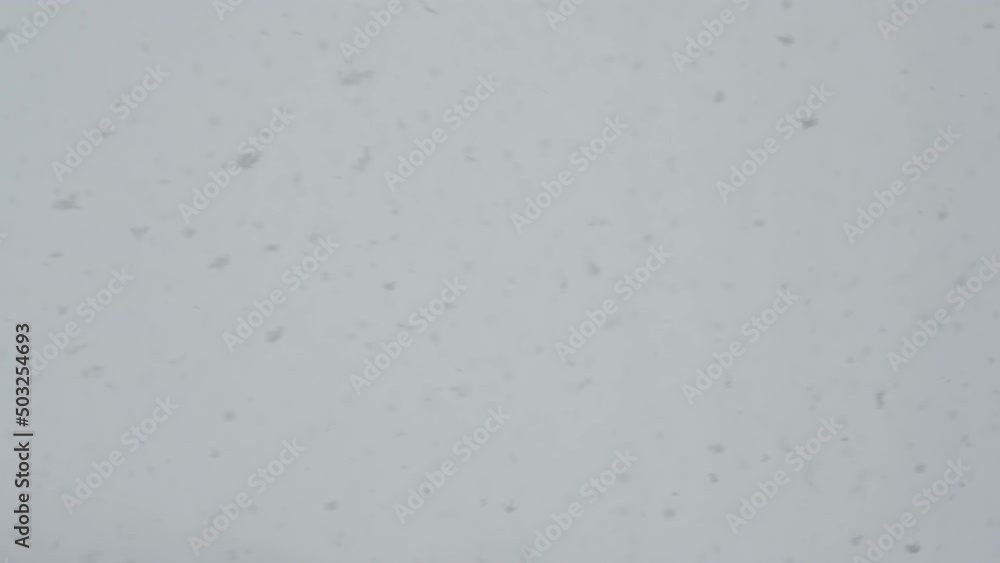Slow motion snow falling over white clouds Slow motion snow falling over white clouds