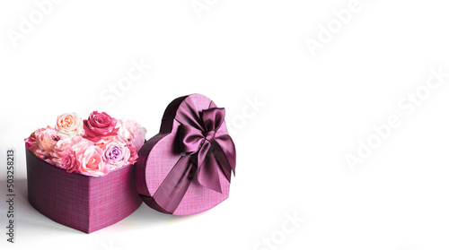 Heart shape gift box and bouquet. Flowers a gift in the shape of a heart. Roses in a box heart on white background.