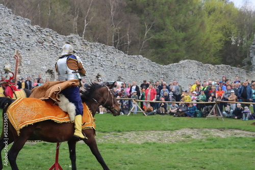 a hussar on a rotten mare in a leopard cape and chain mail gallops with a sword on the preponderance Ogrodzeniec Malopolska Poland - May 1st 2022 photo