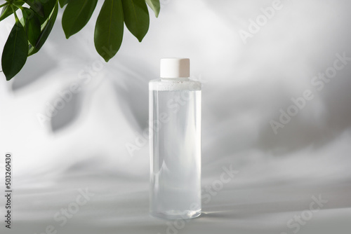 mockup of clean bottle of micellar water on gray background