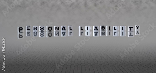 personal liability word or concept represented by black and white letter cubes on a grey horizon background stretching to infinity