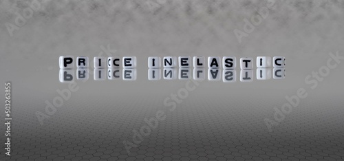 price inelastic word or concept represented by black and white letter cubes on a grey horizon background stretching to infinity