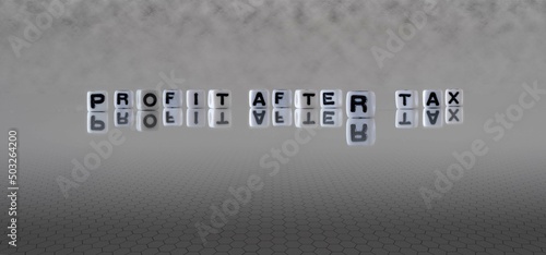 profit after tax word or concept represented by black and white letter cubes on a grey horizon background stretching to infinity