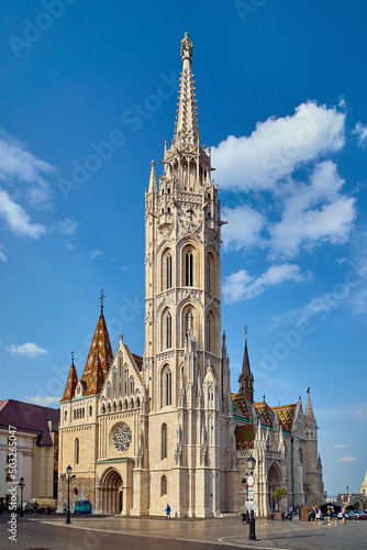 Matthias Church in Budapest, outdoor view of the temple with clouds and blue sky © Radek