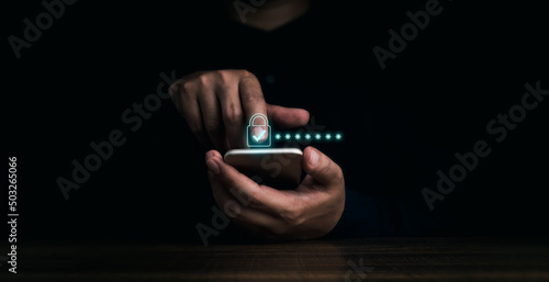 Lock icons and password hidden behind asterisks appear while man's finger touching on mobile phone on dark background. Cyber security, data protection, business privacy technology concept.