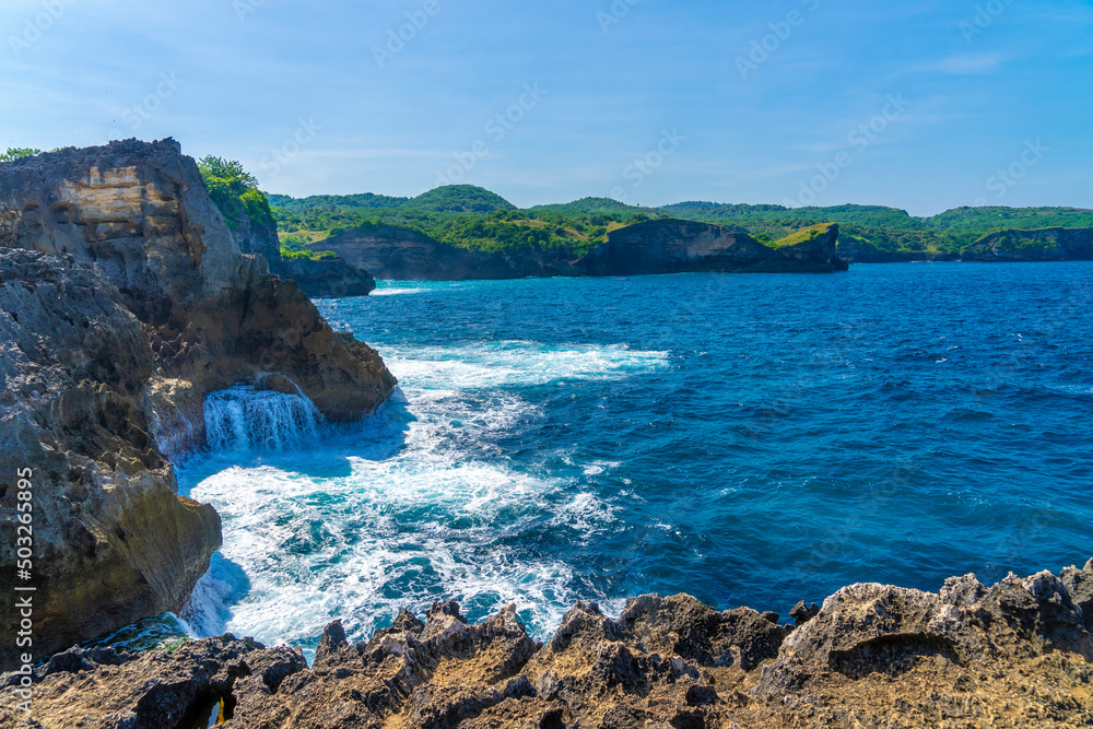 Beautiful crystal water view of angel bilabong in nusa penida island with rock beside it, bali, indonesia