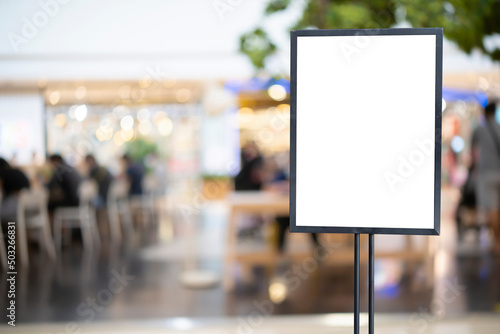 mockup white poster with black frame stand in front of blur restaurant cafe background for show or present promotion