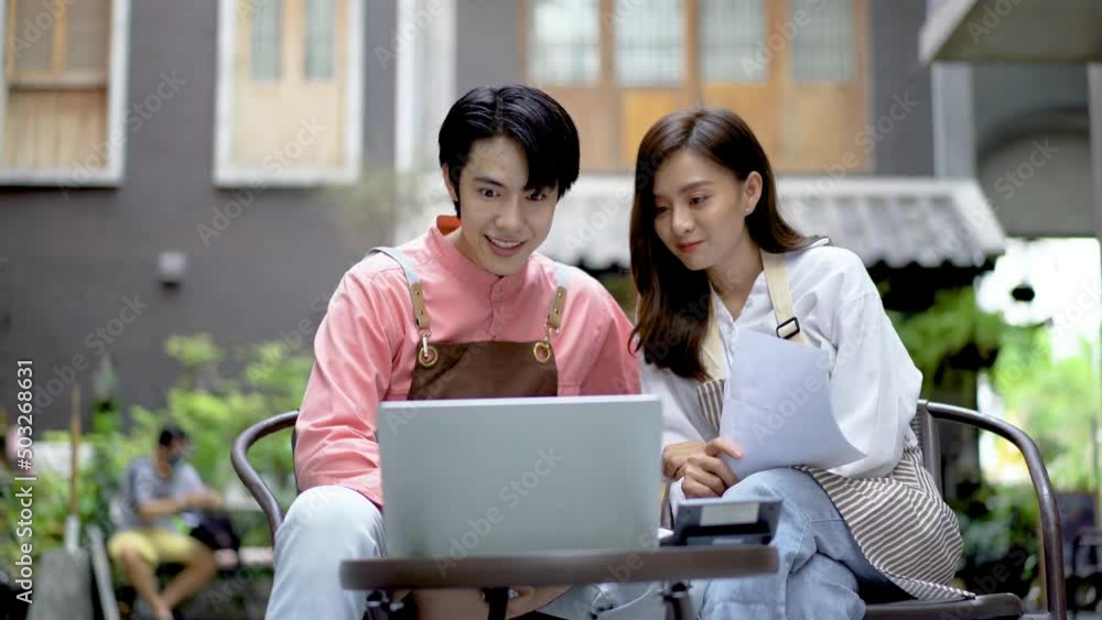 Business partners, Modern couple surfing on internet during coffee break at cafe, use laptop, discuss project, smiling large, give each other hi five, completed the work perfectly, as expected Business partners, Modern couple surfing on internet during coffee break at cafe, use laptop, discuss project, smiling large, give each other hi five, completed the work perfectly, as expected