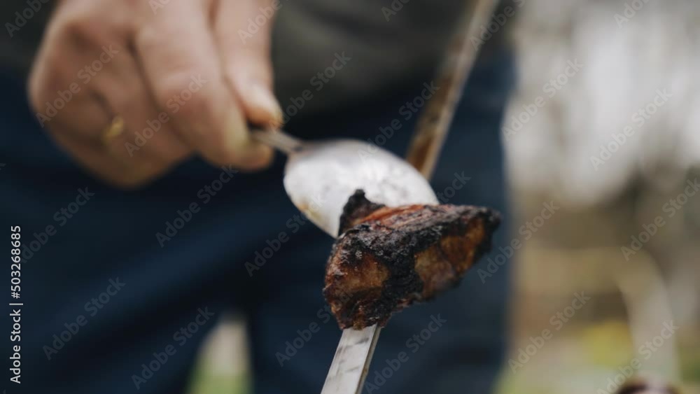 Freshly cooked piece of meat on a skewer. It is removed from the skewer after cooking Freshly cooked piece of meat on a skewer. It is removed from the skewer after cooking
